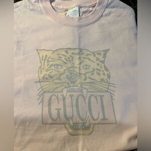 Women’s medium white screen print and women’s pink screen print.